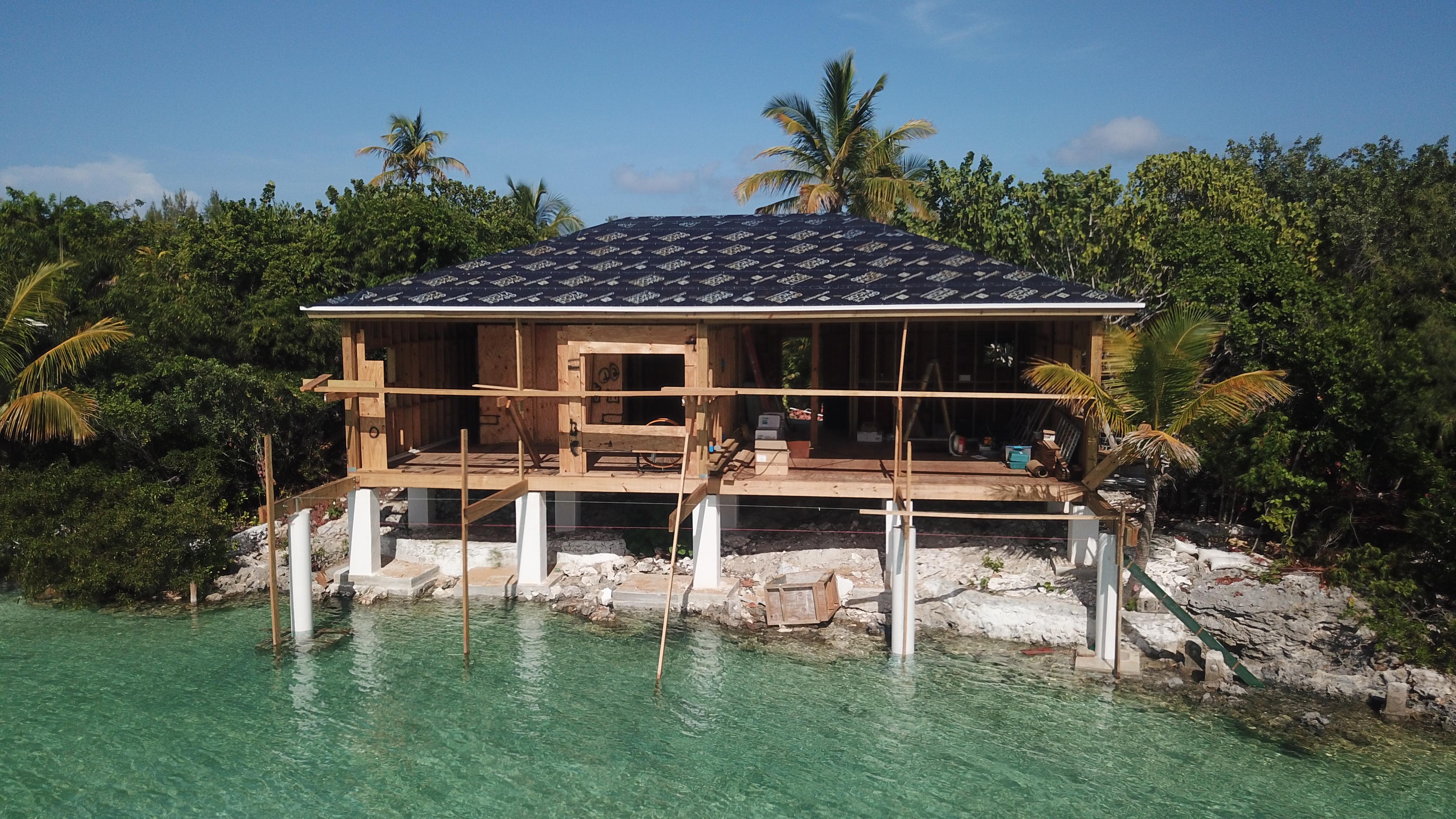 Double bungalows under construction over turquoise water